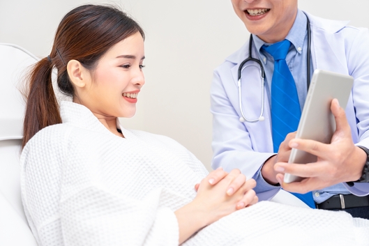 Doctor showing a patient treatment progress on a tablet