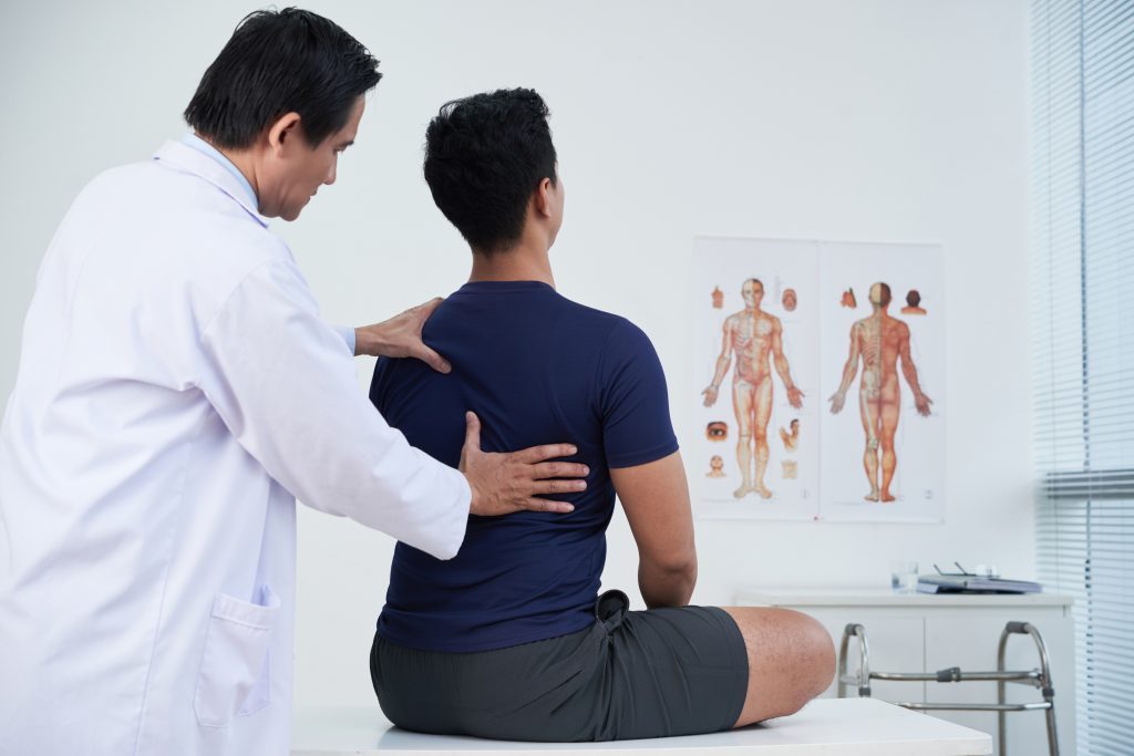 Physiotherapist chiropractor provides treatments to patient